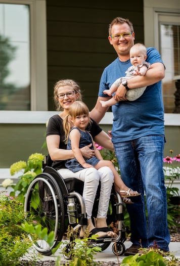 family with two small children and mother in a wheelchair