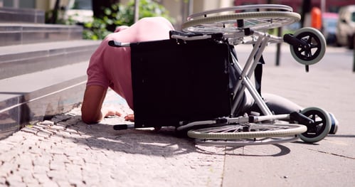 man falling out of wheelchair