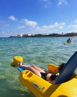 Alma Silver swimming in the Mediterranean Sea using an aquatic wheelchair