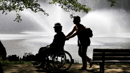 person in wheelchair with caregiver