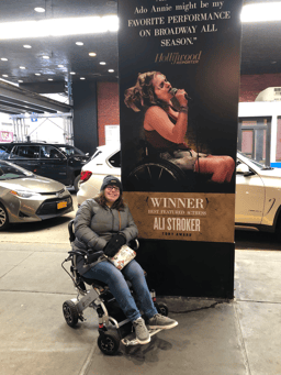 Elizabeth McCormick in front of Ali Stroker poster