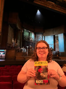 Elizabeth McCormick with Hadestown playbill