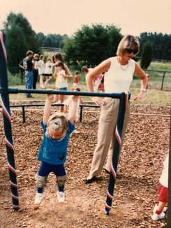 Jill standing in playground with little girl