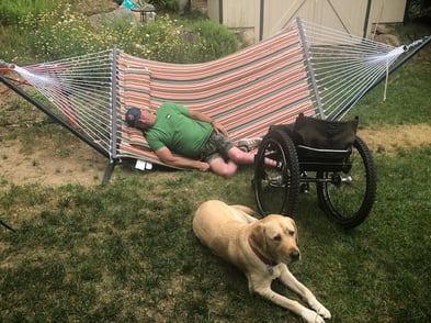 Geoff Krill and dog in hammock 
