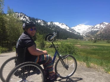 Jessica riding an adaptive bike in the mountains