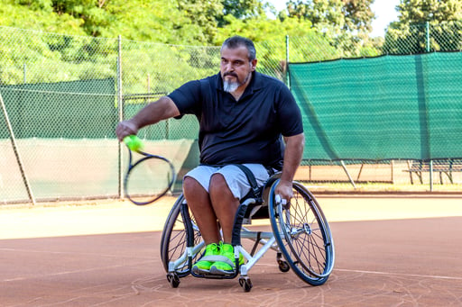 Man in wheelchair playing tennis