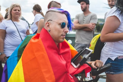 wheelchair user wearing a pride flag