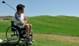 man in wheelchair playing golf