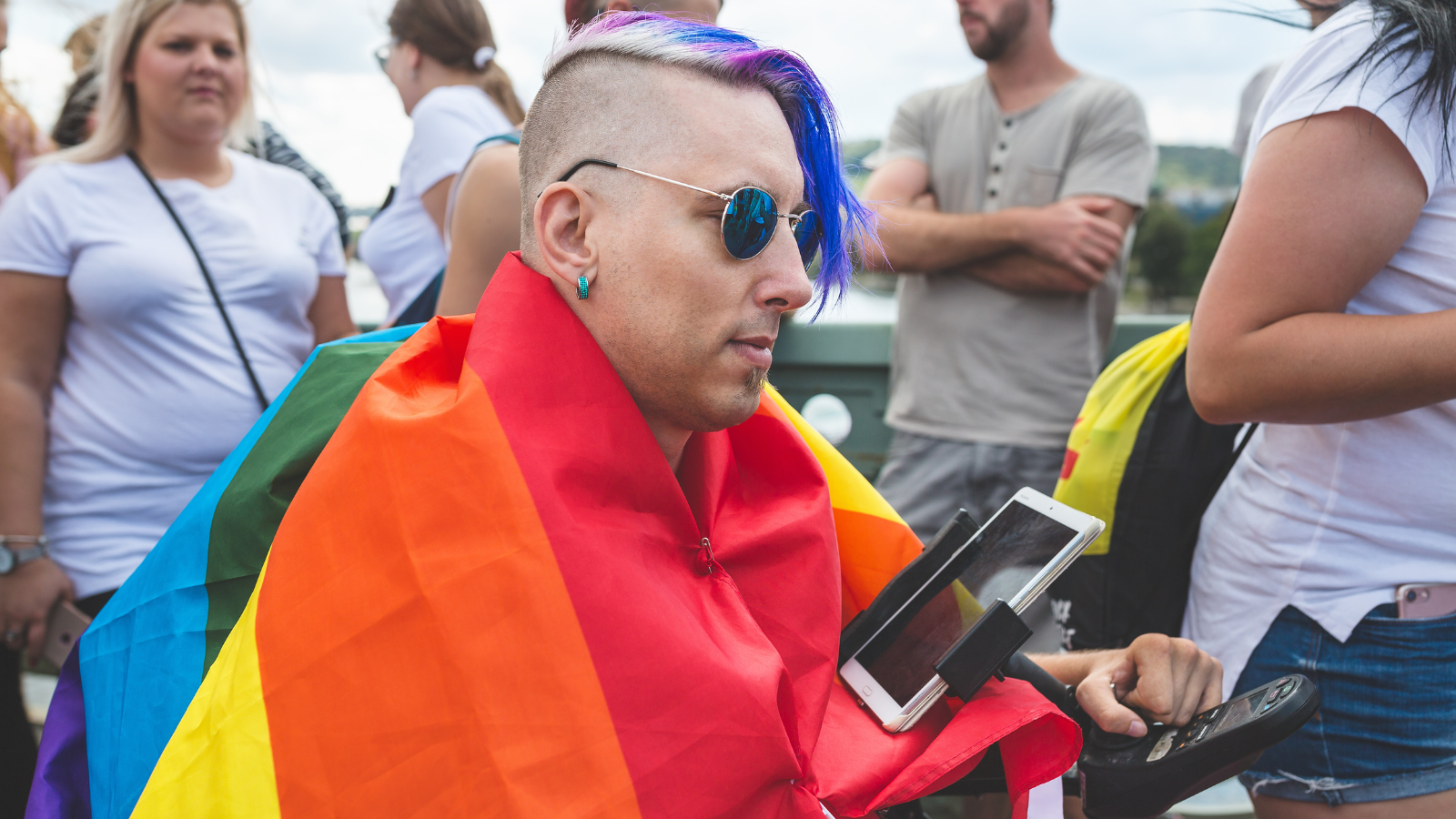 wheelchair user wearing a pride flag 