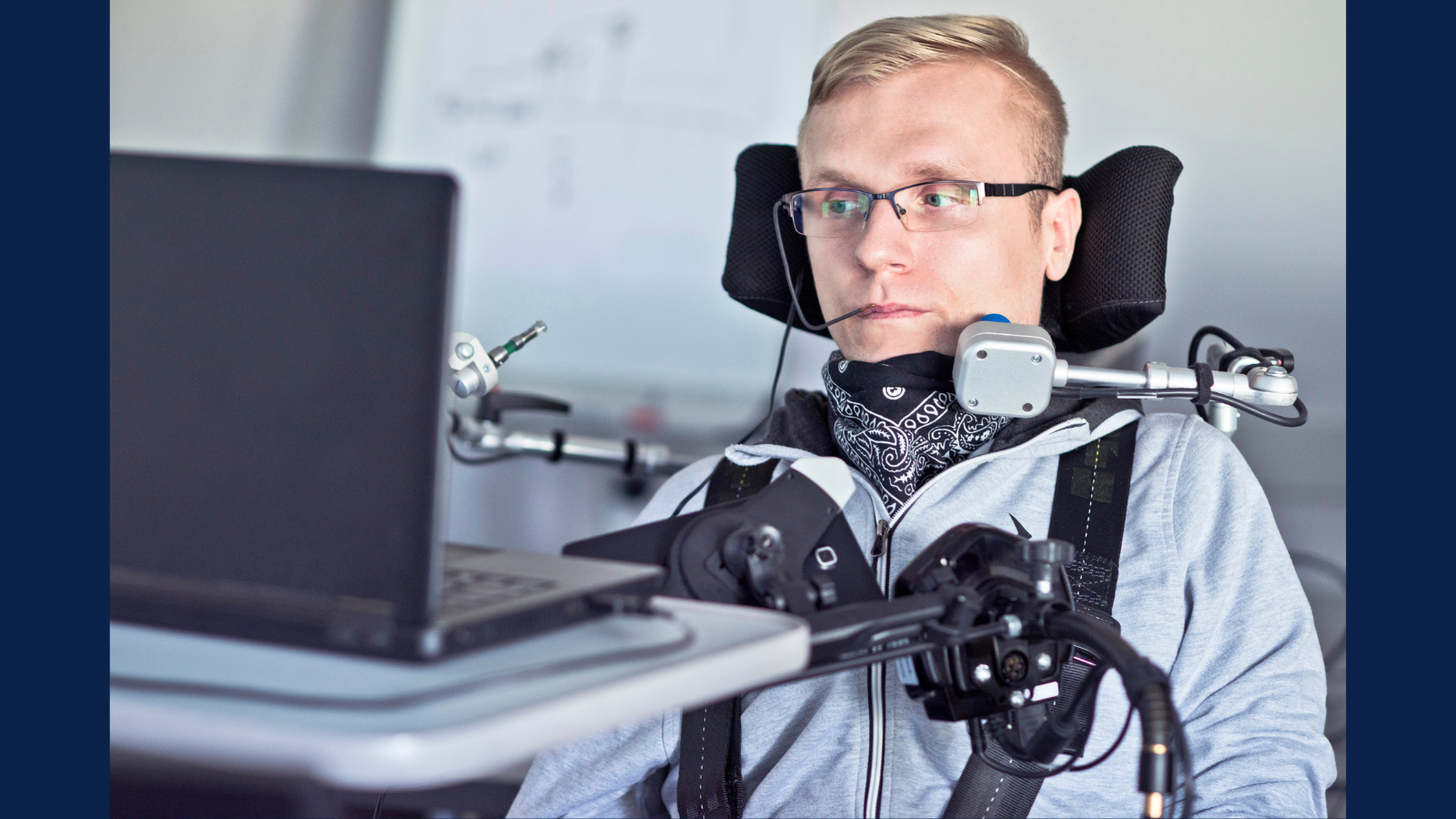 man in chair with assistive technology