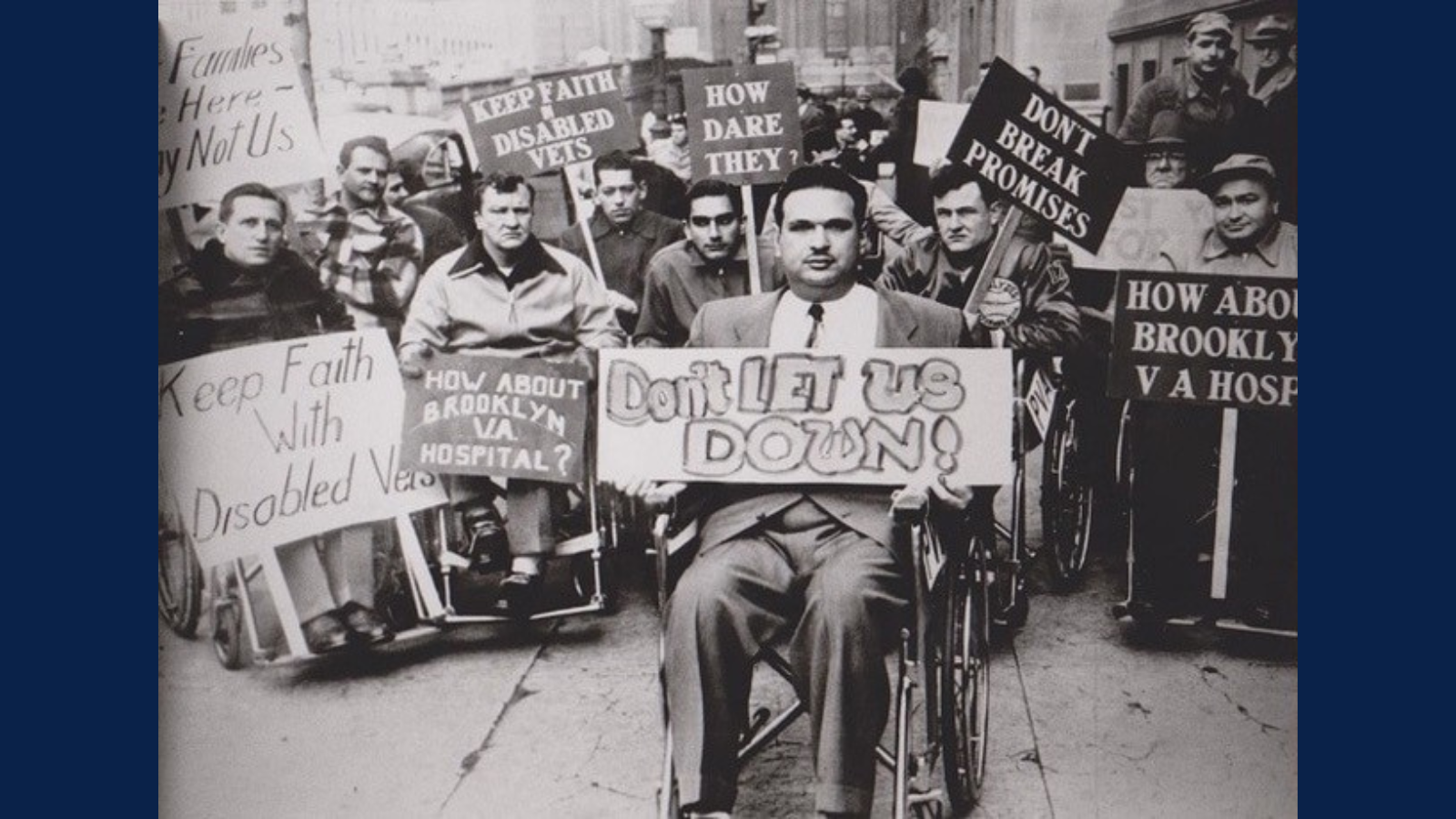 People in wheelchairs holding signs