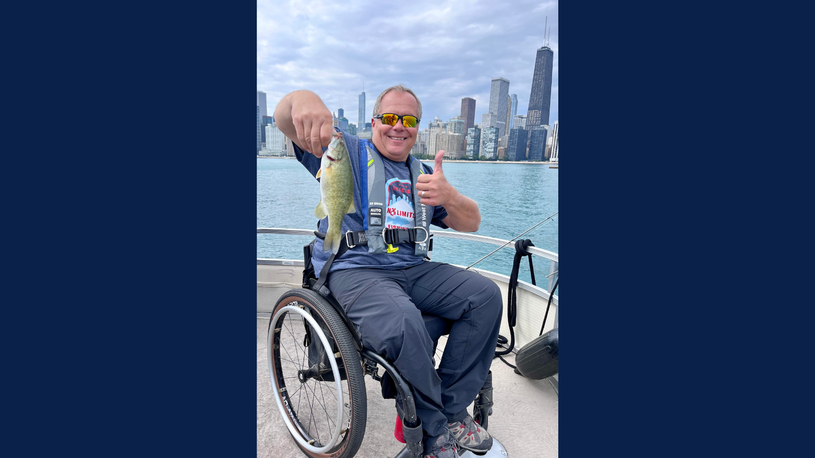 Man in wheelchair with a fish in hand on boat