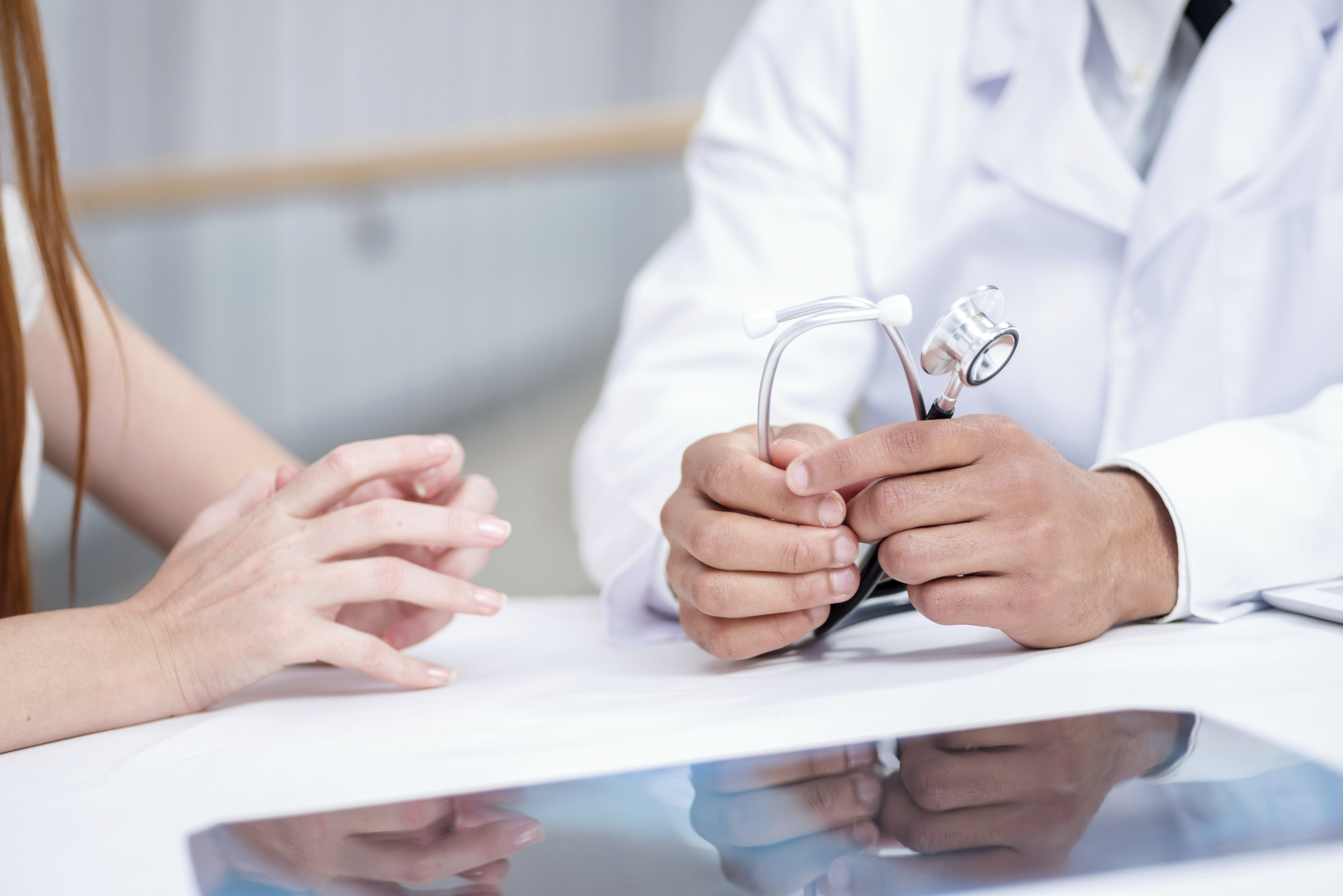 Torso shot: hands of a doctor and patient