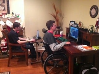 Zack Collie and Dylan with their video game setup