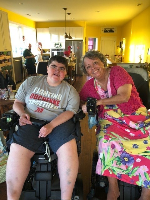 Lorraine wearing a floral dress next to her son