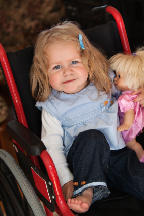 child in stroller posing with doll