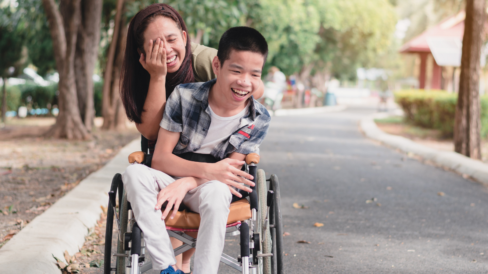 Child in wheelchair with caregiver