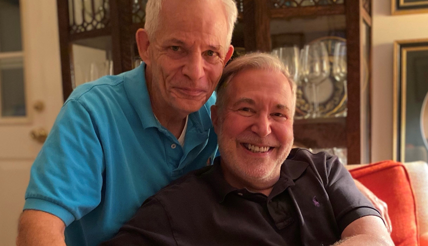 Howard Menaker (sitting) and his husband